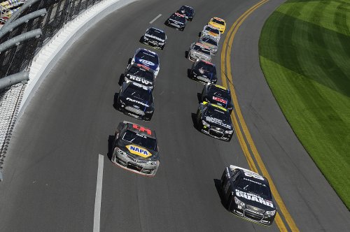 Martin Truex Jr. (56) and Dale Earnhardt Jr. (88) lead a group of cars through the tri-oval during NASCAR Sprint Cup Series Preseason Thunder testing at Daytona International Speedway Friday.  Photo by Jared C. Tilton/Getty Images for NASCAR