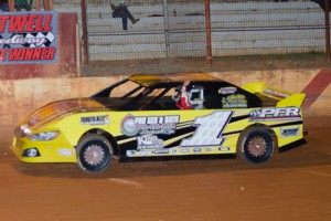 Jeremy Hicks waves to the crowd as he crosses under the checkered flag to win Saturday night's Young Guns feature at Hartwell Speedway.  Photo by Heather Rhoades