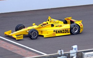 Helio Castroneves crosses the yard of bricks at the start/finish line in Thursday's practice session at the Indianapolis Motor Speedway.  Photo by Mike Harding