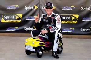 Kevin Harvick poses with the pole award after qualifying on the pole for Saturday night's NASCAR Sprint Cup Series race at Kansas Speedway. Photo by Jamie Squire/NASCAR via Getty Images