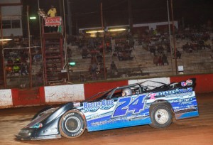 Michael Page waves as he races under the checkered flag to score the Super Late Model victory Saturday night at Dixie Speedway.  Photo by Kevin Prater/praterphoto.com