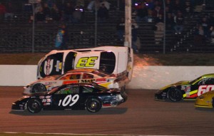 Richie Dearborn (33) took this hard ride into the outside wall on a mid-race restart in Saturday night's Littleton Chevrolet 150.  Photo by Norm Marx