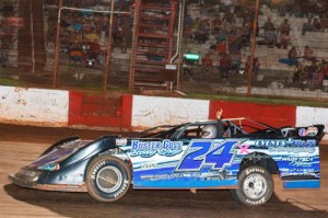 Michael Page waves to the crowd as he races under the checkered flag to become the only two-time Super Late Model winner of the 2014 season at Dixie Speedway.  Photo by Kevin Prater/praterphoto.com