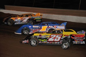 Donald McIntosh (7), Josh Richards (1) and Shane Clanton battle for the early lead in Saturday's World of Outlaws Late Model feature.  Photo by MRM Racing Photos