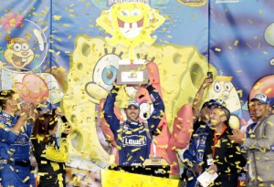 Jimmie Johnson celebrates with the trophy in victory lane after winning the NASCAR Sprint Cup Series SpongeBob SquarePants 400 at Kansas Speedway Saturday night.  Photo by Jerry Markland/Getty Images