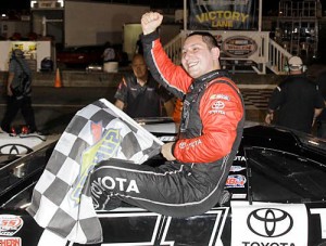 Kaz Grala climbs from his car in victory lane after scoring the win in Saturday night's PASS South Super Late Model feature at South Boston Speedway.  Photo by James Price