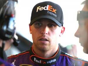 Denny Hamlin stands in the garage area during practice for Sunday's NASCAR Sprint Cup Series race at Indianapolis Motor Speedway.  Photo by Jerry Markland/Getty Images