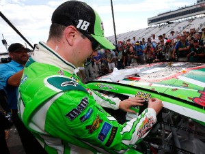 Kyle Busch applies the winner's decal to his car after winning Sunday's NASCAR Sprint Cup Series race at New Hampshire Motor Speedway.  He hopes to add another decal to his collection in Sunday's race at the Indianapolis Motor Speedway.  Photo by Jonathan Ferrey/NASCAR via Getty Images