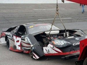 Harrison Burton's car is towed back to the pits after contact with the wall during Thursday's practice for the Snowball Derby at 5 Flags Speedway. Photo by Matt Weaver