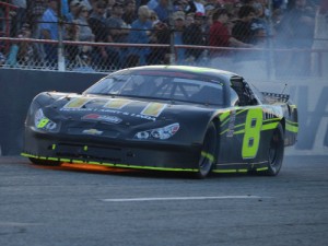 Flames shoot out from under John Hunter Nemechek's Chevy as he tries to finish Sunday's Snowball Derby. He was forced to pit with five laps remaining. Photo by Eddie Richie/Turn One Photos/Loxley, AL