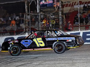 Robert Loper crosses under the checkered flag to score the Bomber Snowball Derby feature Thursday at 5 Flags Speedway.  Photo by Eddie Richie/Turn One Photos/Loxley, AL