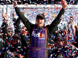 Denny Hamlin celebrates in victory lane after winning Sunday's Daytona 500 in a photo finish. Photo by Sarah Crabill/NASCAR via Getty Images