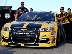 Crew members push the car of Ty Dillon through the garage area during Wedneday's practice for the Daytona 500 at Daytona International Speedway.  Photo by Sarah Crabill/NASCAR via Getty Images