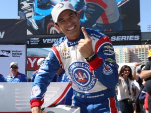 Helio Castroneves affixes the Verizon P1 Award emblem for winning the pole for Sunday's Toyota Grand Prix of Long Beach.  Photo by Chris Jones