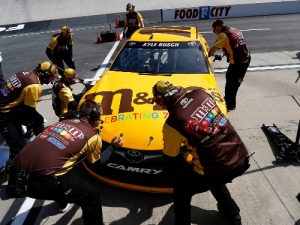 Crew members work on Kyle Busch's #18 M&M's Toyota prior to Friday's practice for Sunday's NASCAR Sprint Cup Series race at Bristol Motor Speedway.  Photo by Matt Hazlett/Getty Images