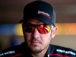 Martin Truex, Jr. stands in the garage during practice for Sunday's NASCAR Sprint Cup Series race at Dover International Speedway.  Photo by Sean Gardner/Getty Images