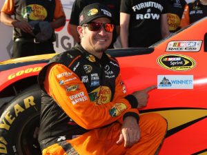 Martin Truex, Jr. poses for a photo after winning the pole award during qualifying for this weekend's NASCAR Sprint Cup Series race at Kansas Speedway.  Photo by Sean Gardner/NASCAR via Getty Images