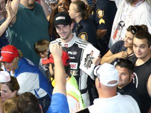 Indy 500 Champion Alexander Rossi signs autographs in the grandstands during the delay for the Firestone 600 at Texas Motor Speedway.  Photo by Chris Jones