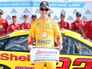 Joey Logano poses with the Coors Light Pole Award after score the pole for Sunday's NASCAR Sprint Cup Series race at Michigan International Speedway.  Photo by Sean Gardner/NASCAR via Getty Images