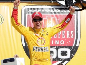 Joey Logano celebrates in victory lane after winning Sunday's NASCAR Sprint Cup Series race at Michigan International Speedway.  Photo by Kena Krutsinger/Getty Images