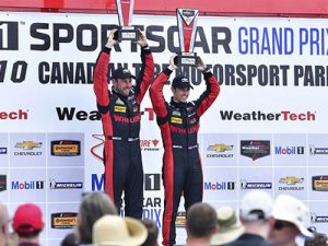 Eric Curran and Dane Cameron celebrate after winning the overall win in the Action Express Corvette Daytona Prototype Sunday for the IMSA WeatherTech SportsCar Championship at Canadian Tire Motorsport Park. Photo by Richard Dole LAT Photo USA