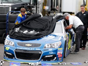 Crew members work on the car of Jimmie Johnson after an incident during Friday's practice for the NASCAR Sprint Cup Series race at Kentucky Speedway.  Photo by Brian Lawdermilk/NASCAR via Getty Images